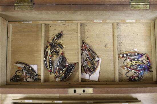 A fitted box containing seven trays of salmon fishing flies